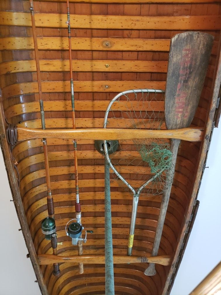 Vintage fishing gear displayed inside an antique canoe